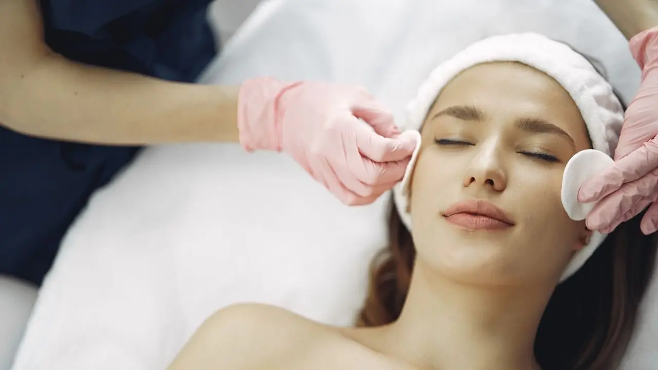 Tratamento facial com luvas cor-de-rosa